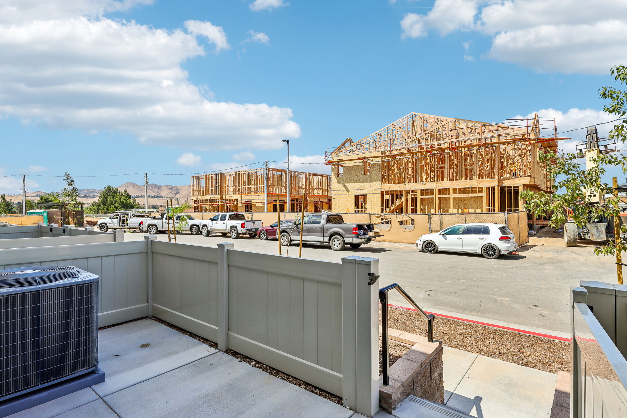 A parking lot with cars and buildings.