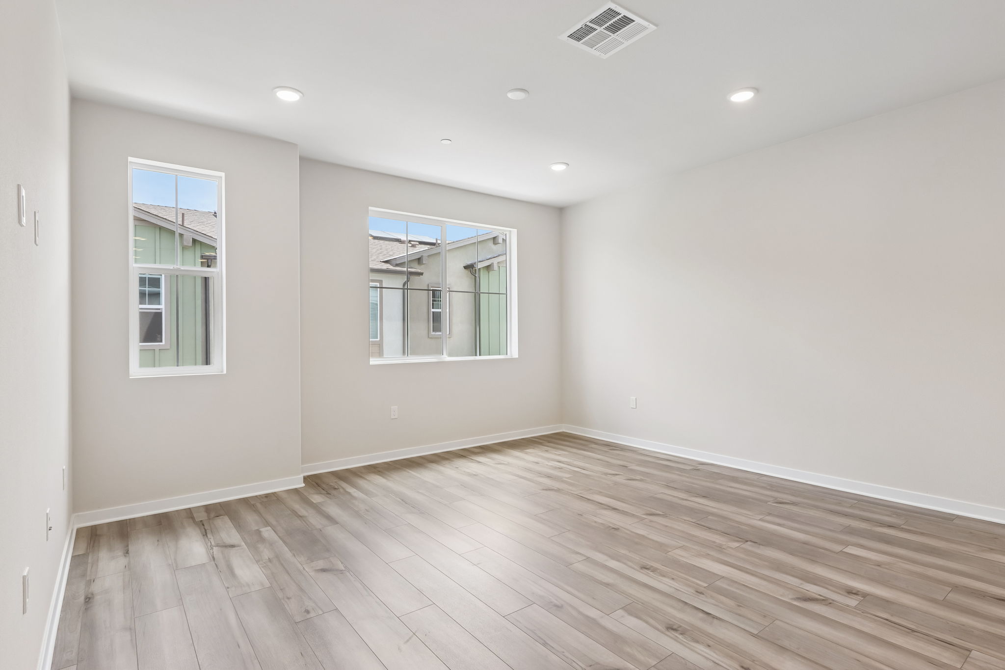 A room with a wood floor and a window.