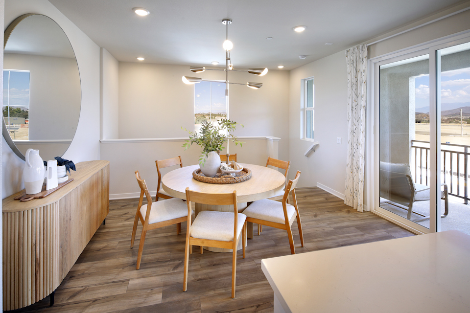 A dining room with a table and chairs.