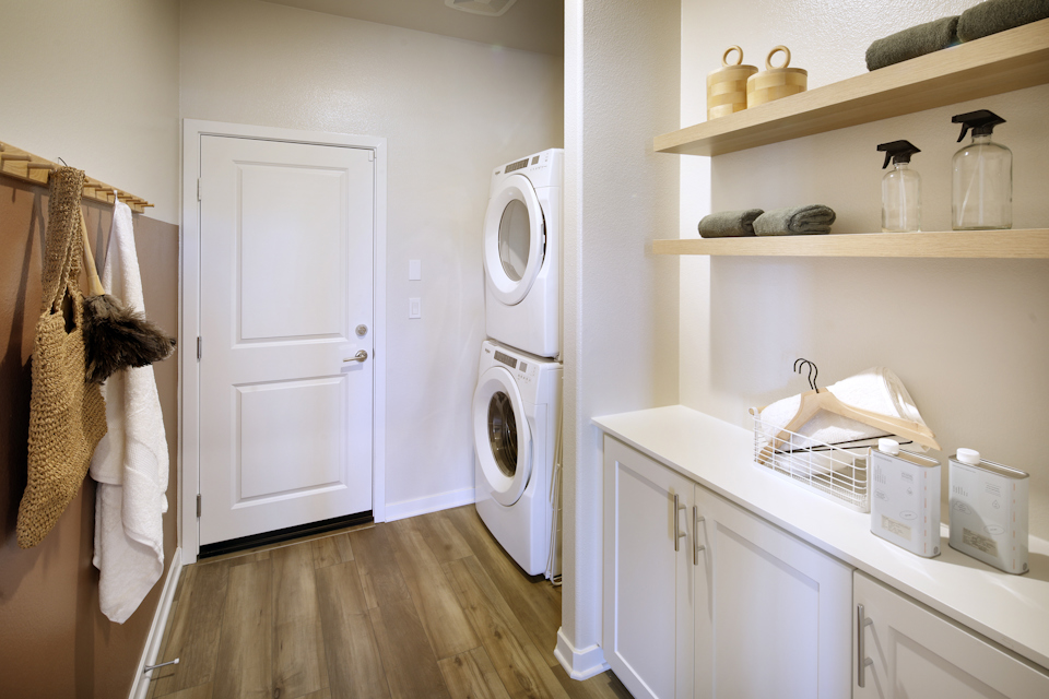 A white kitchen with a washer and dryer.