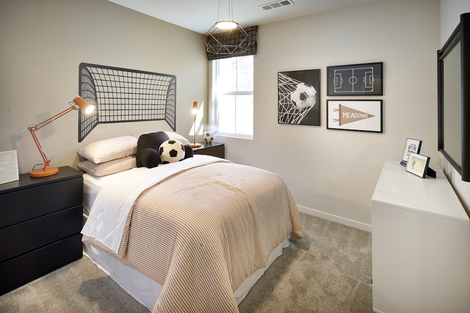 A bedroom with a bed and a lamp.