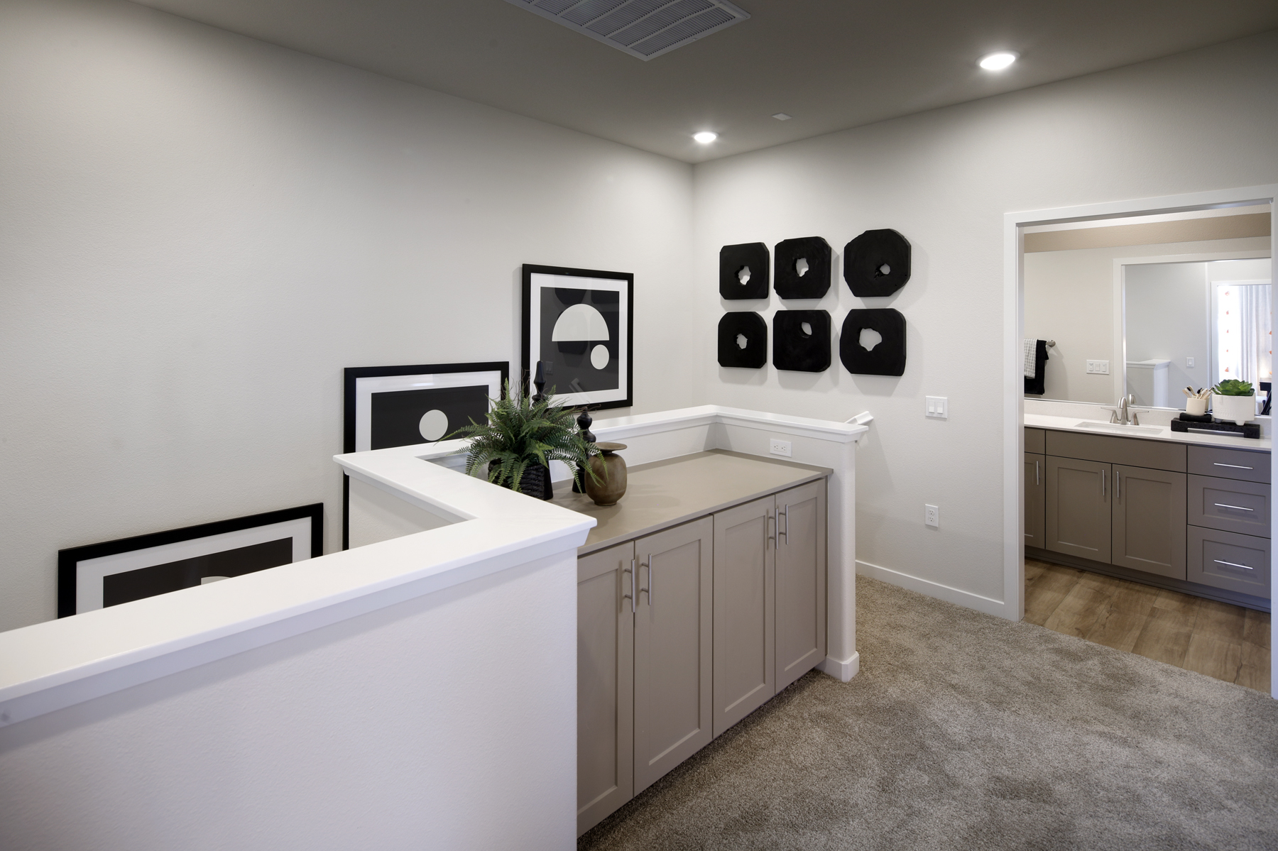 A bathroom with white cabinets.