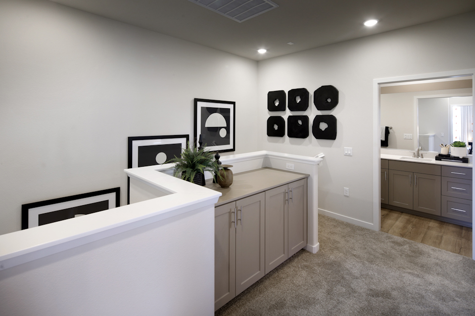 A bathroom with white cabinets.