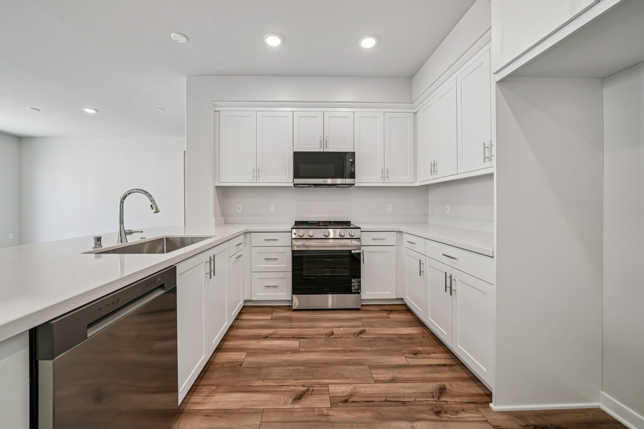 A kitchen with white cabinets.