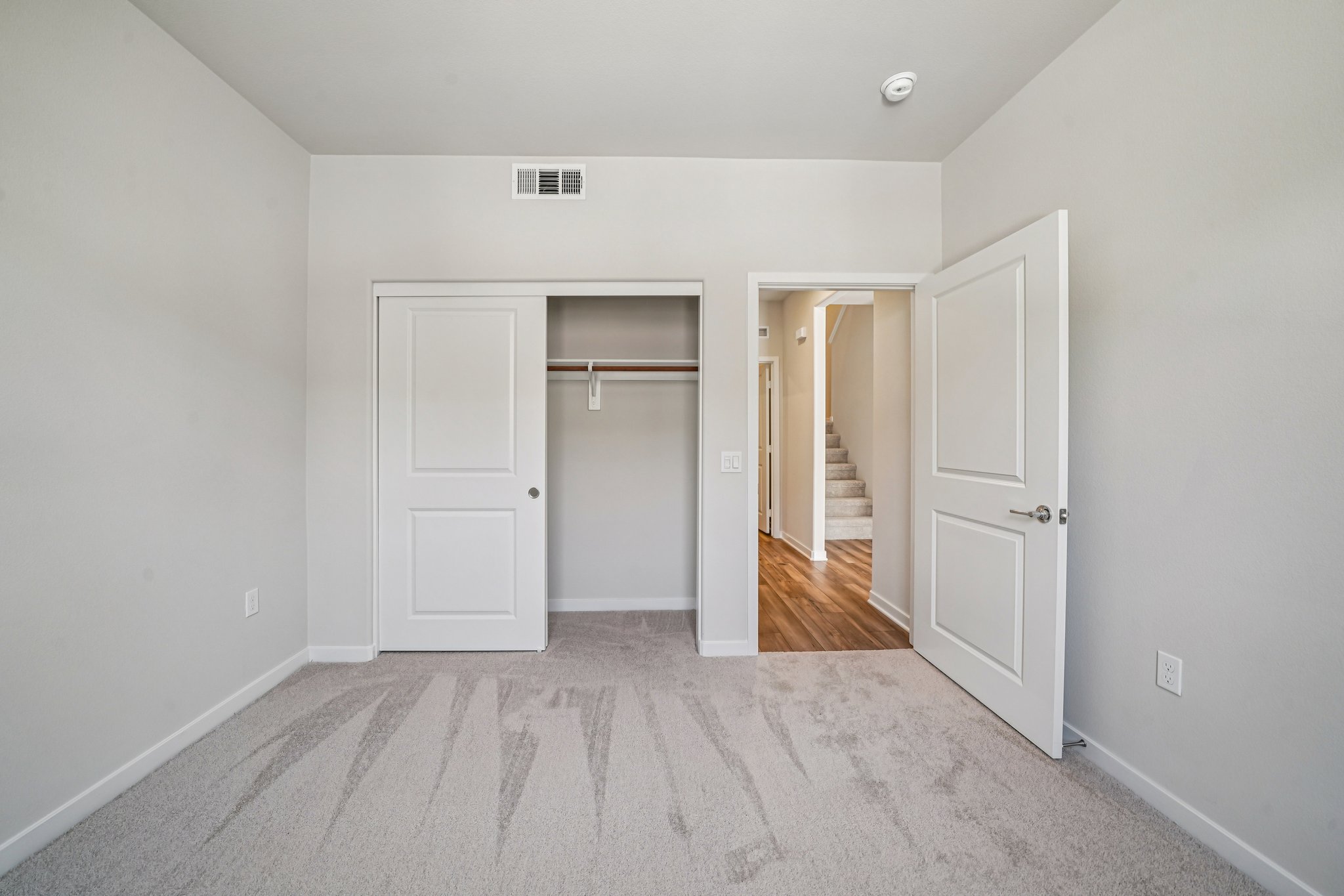 A hallway with white doors.