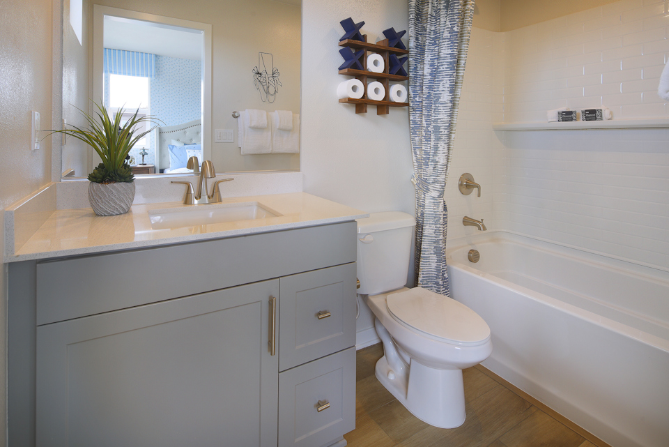 A bathroom with a sink toilet and bathtub.