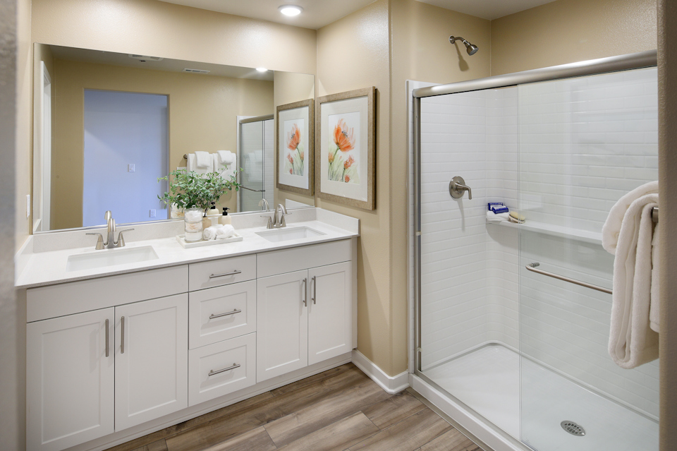 A bathroom with a shower and sink.