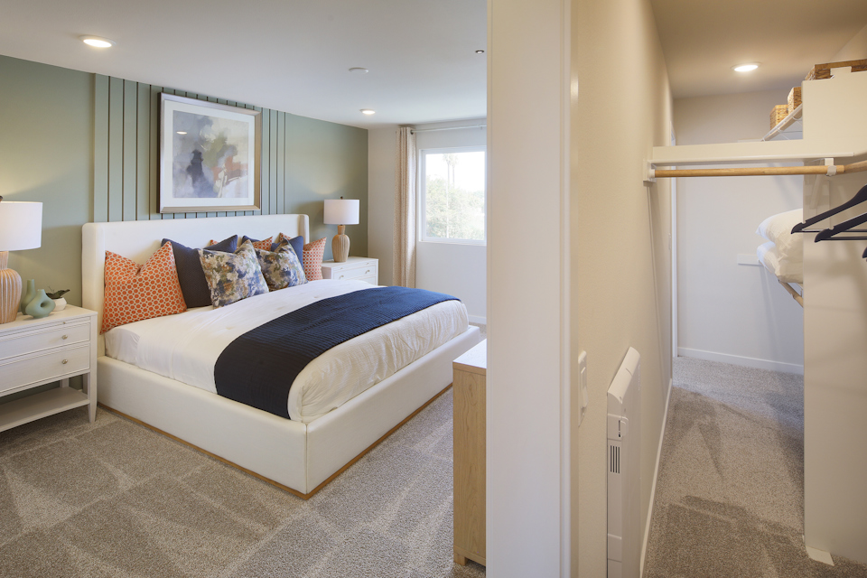 A bedroom with a bed and lamps.