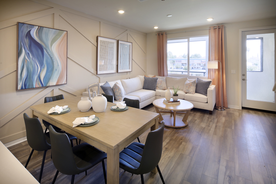 A living room with a large table and chairs.