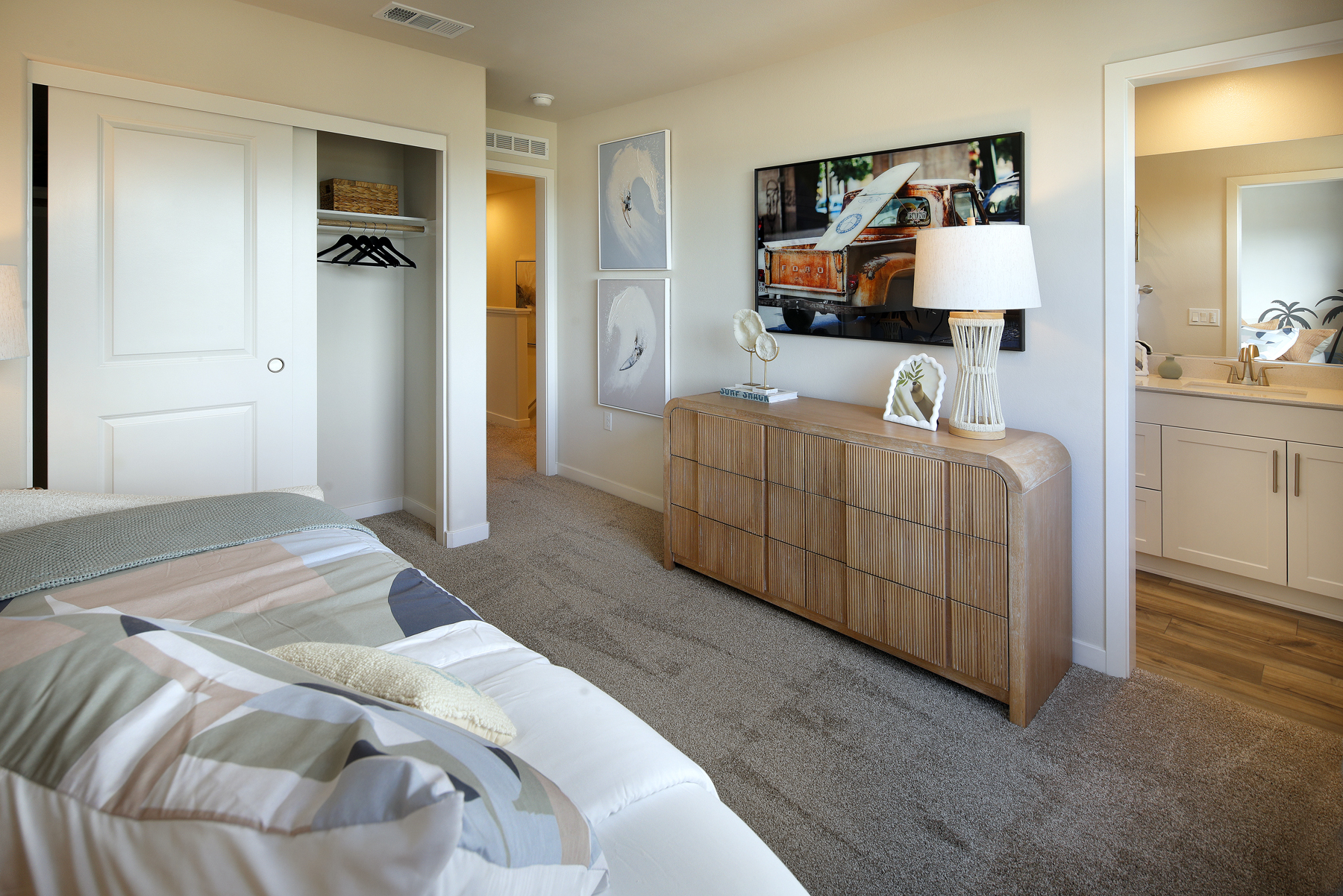 A bedroom with a bed and a dresser.