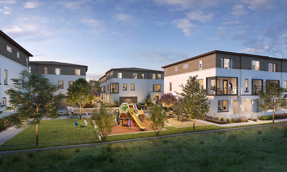 A group of buildings with trees and grass in front of them.