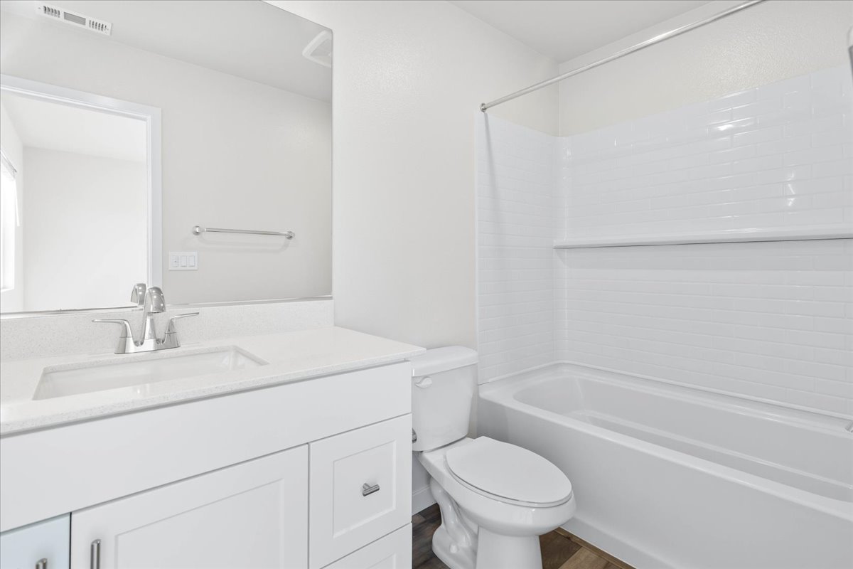 A bathroom with a toilet sink and bathtub.
