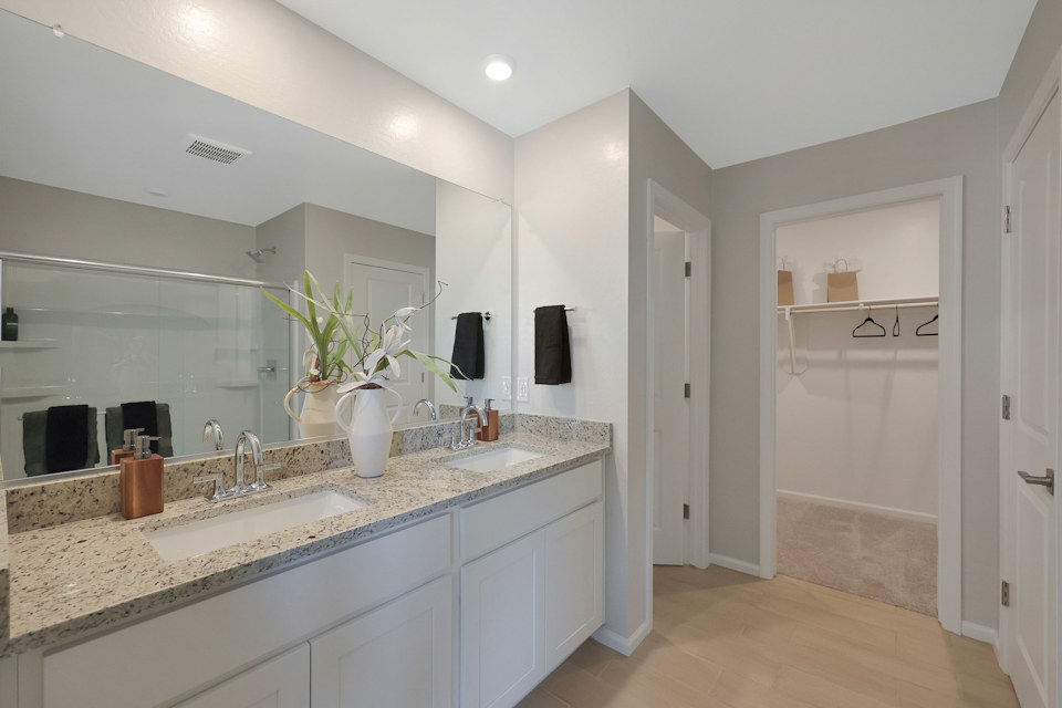A bathroom with a large mirror.