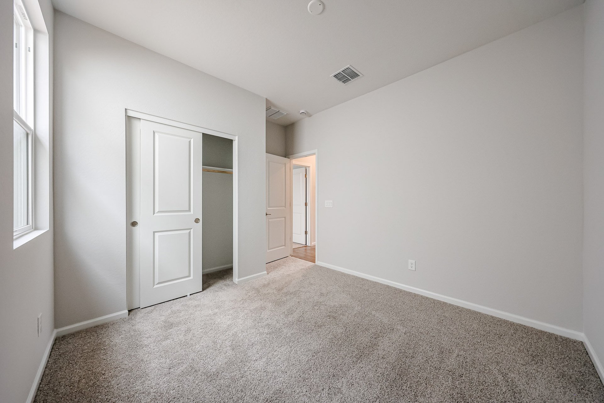 A hallway with white doors.