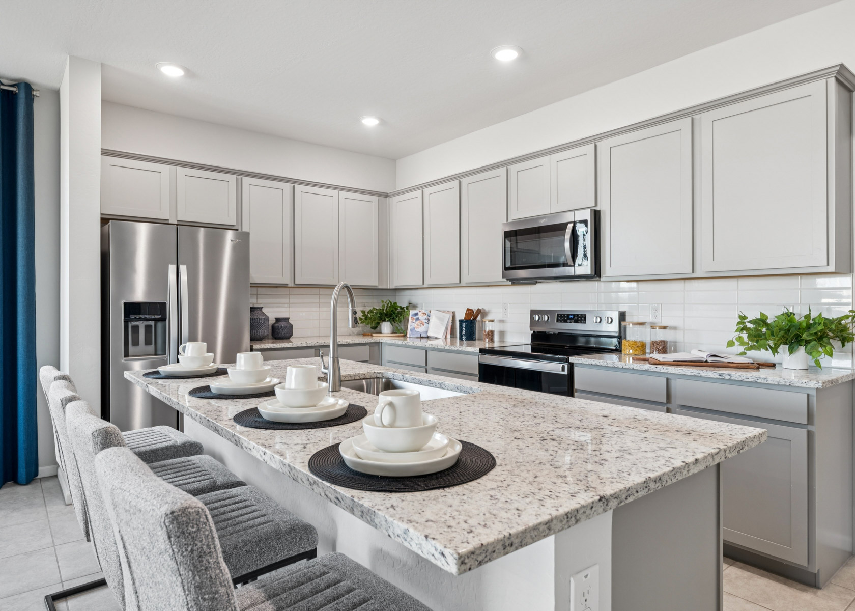 A kitchen with white cabinets.