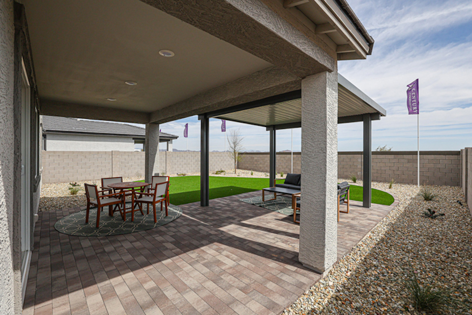 A patio with a table and chairs.