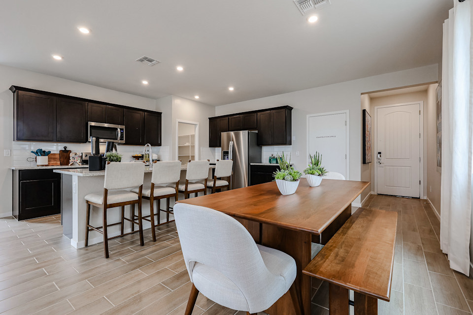 A large kitchen with a dining table.