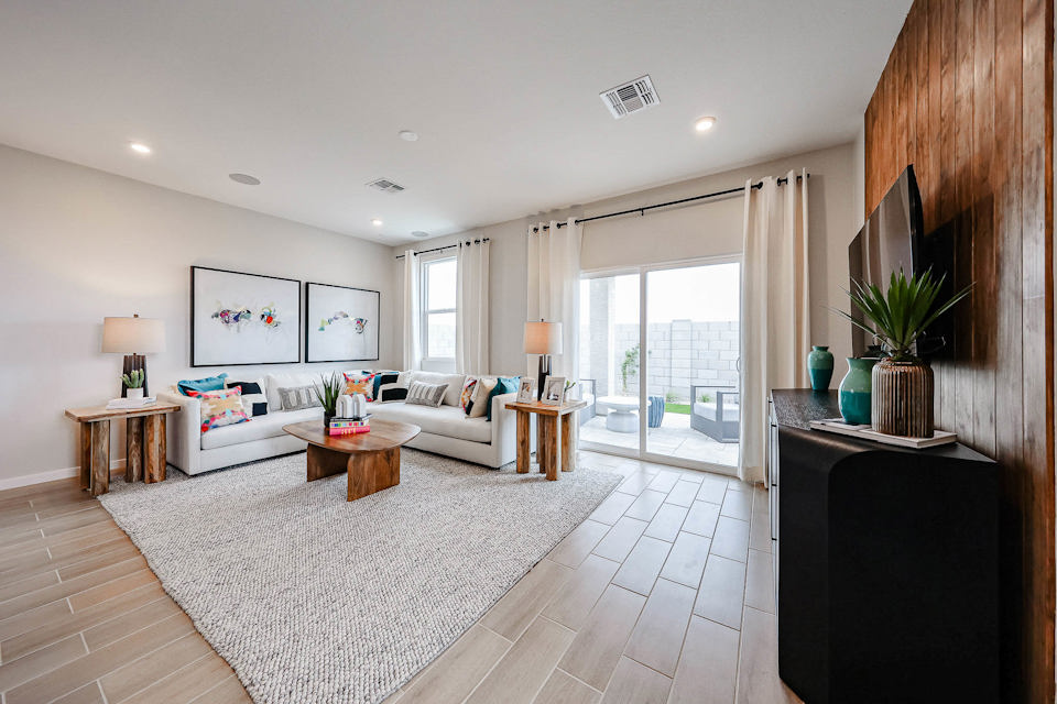 A living room with a large rug.