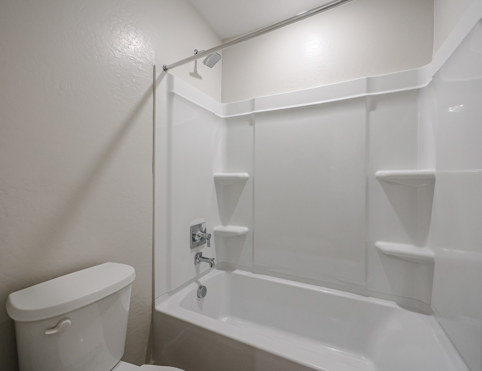 A bathroom with a tub toilet and sink.