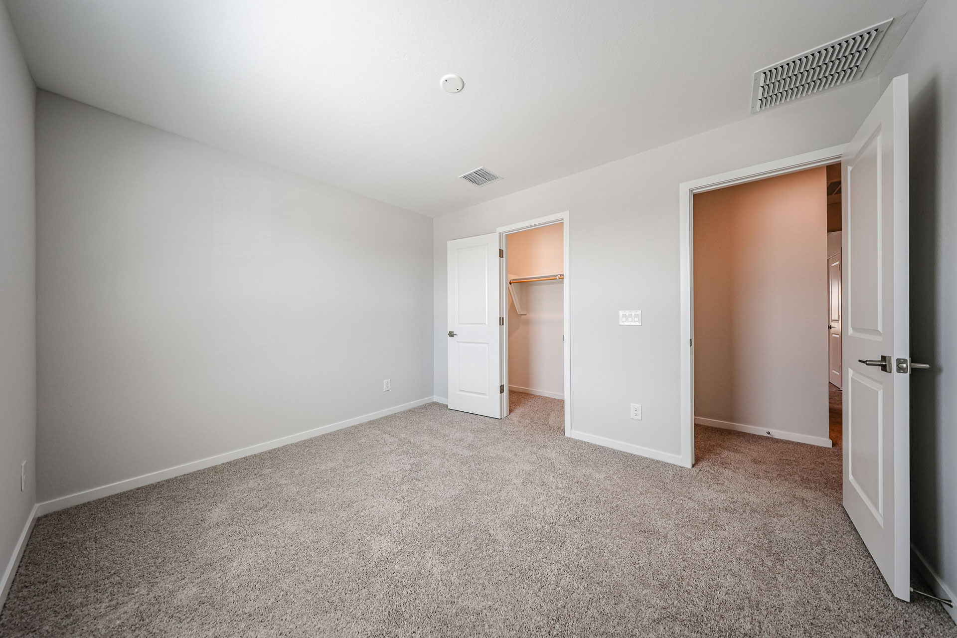 A hallway with white doors.
