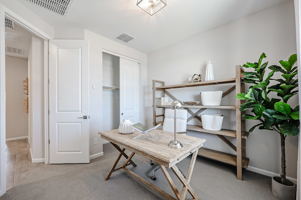 A room with a table and shelves.
