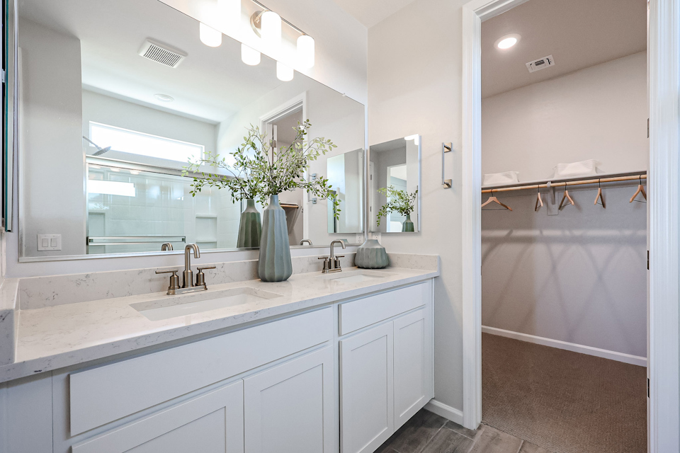 A bathroom with a large mirror.