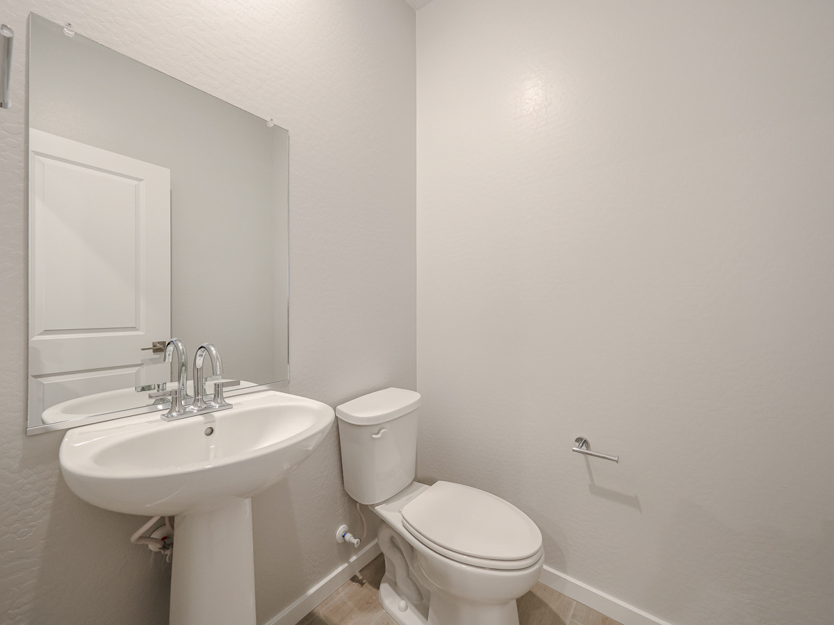 A bathroom with a toilet and sink.