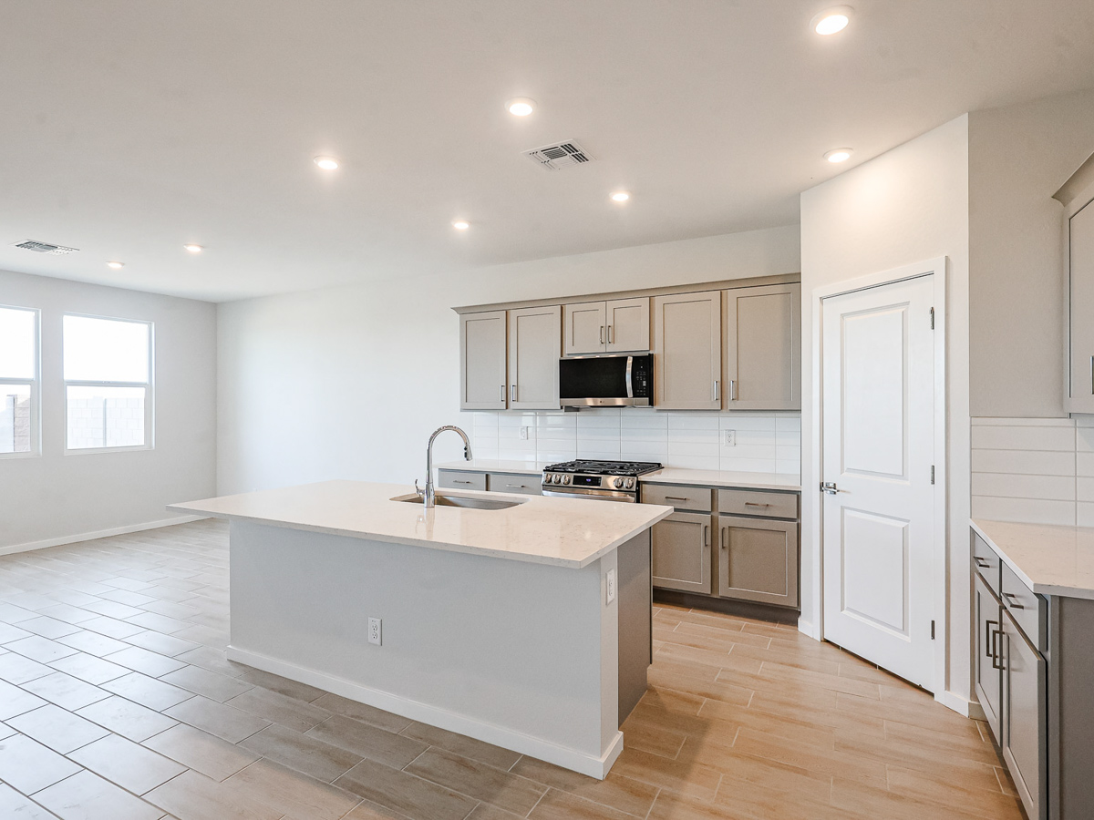 A kitchen with white cabinets.