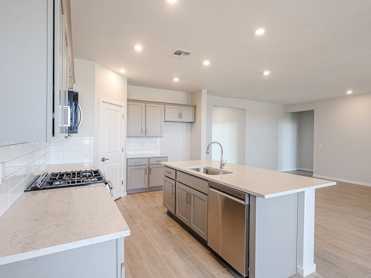 A kitchen with white cabinets.