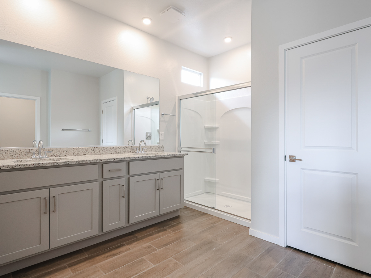 A bathroom with white cabinets.