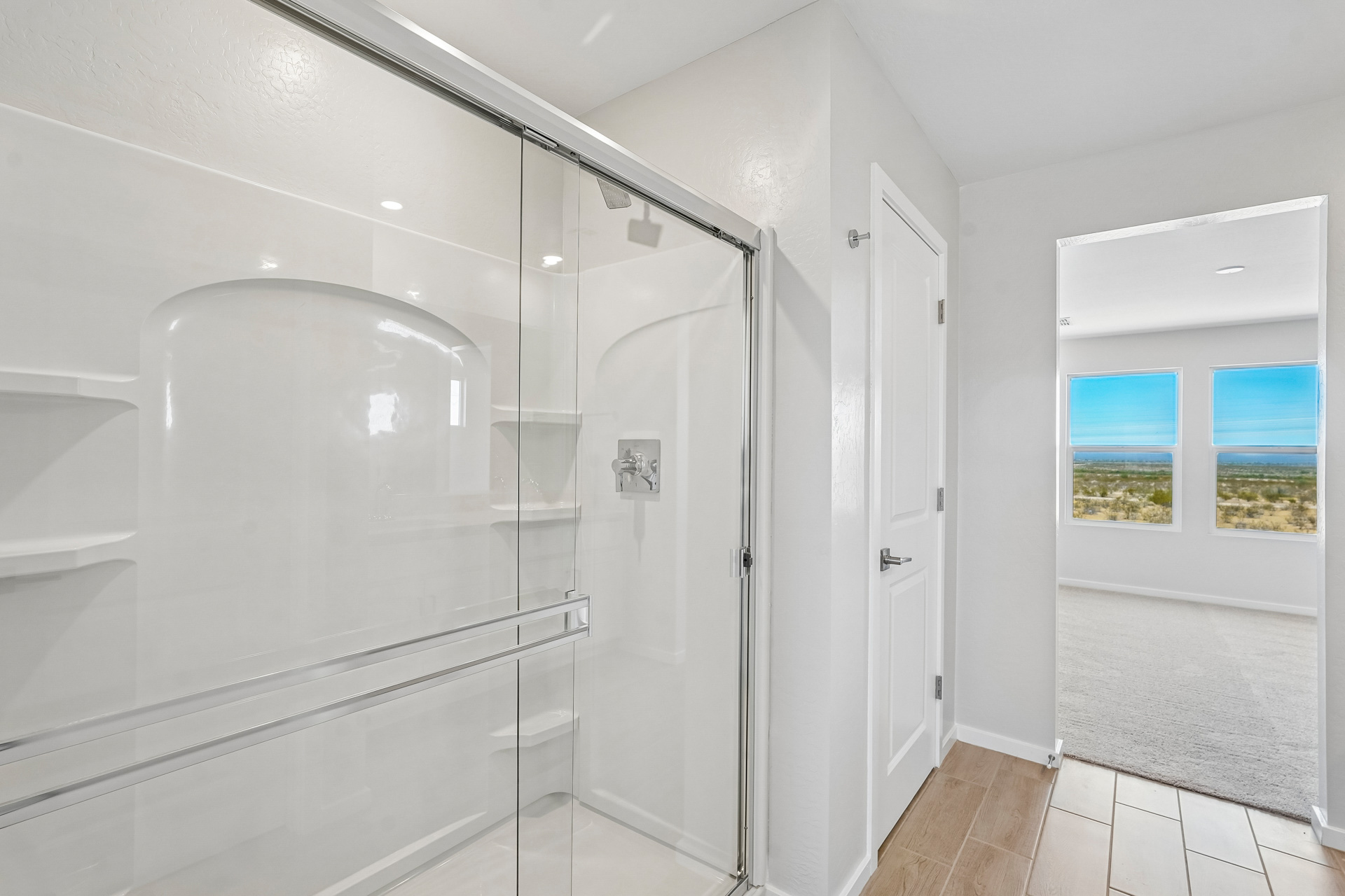 A white bathroom with a glass shower.