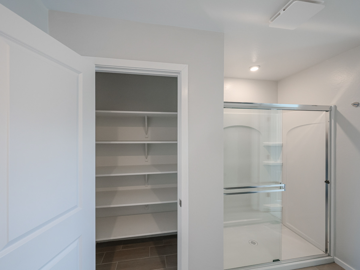 A white room with a glass shower.