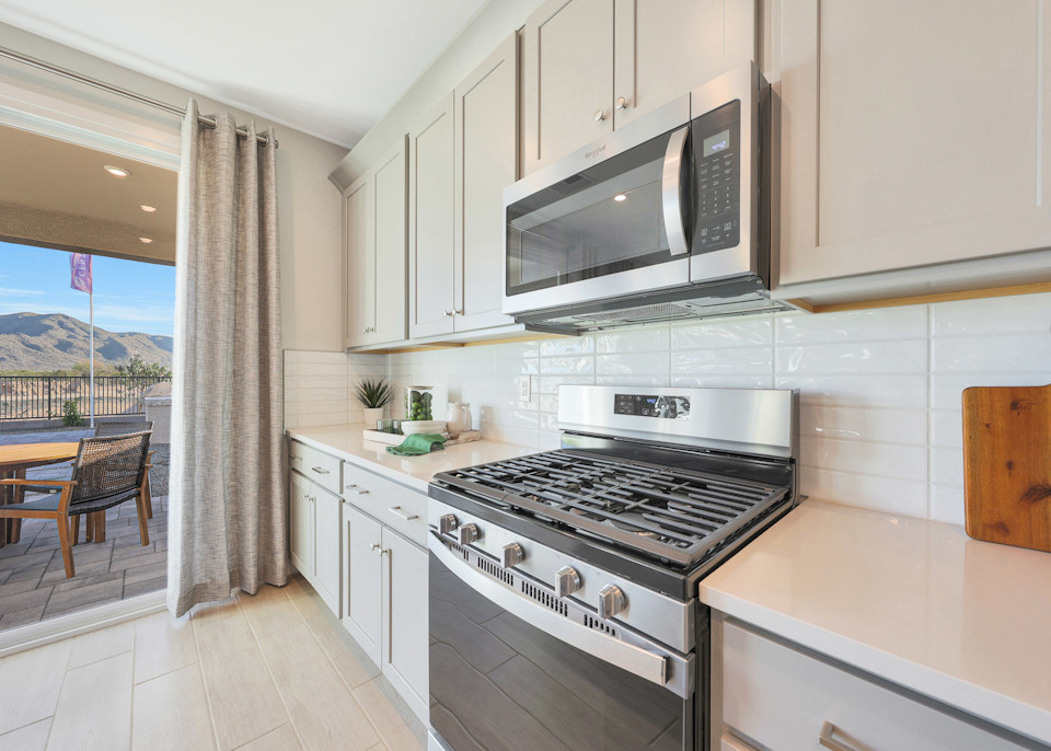 A kitchen with white cabinets.