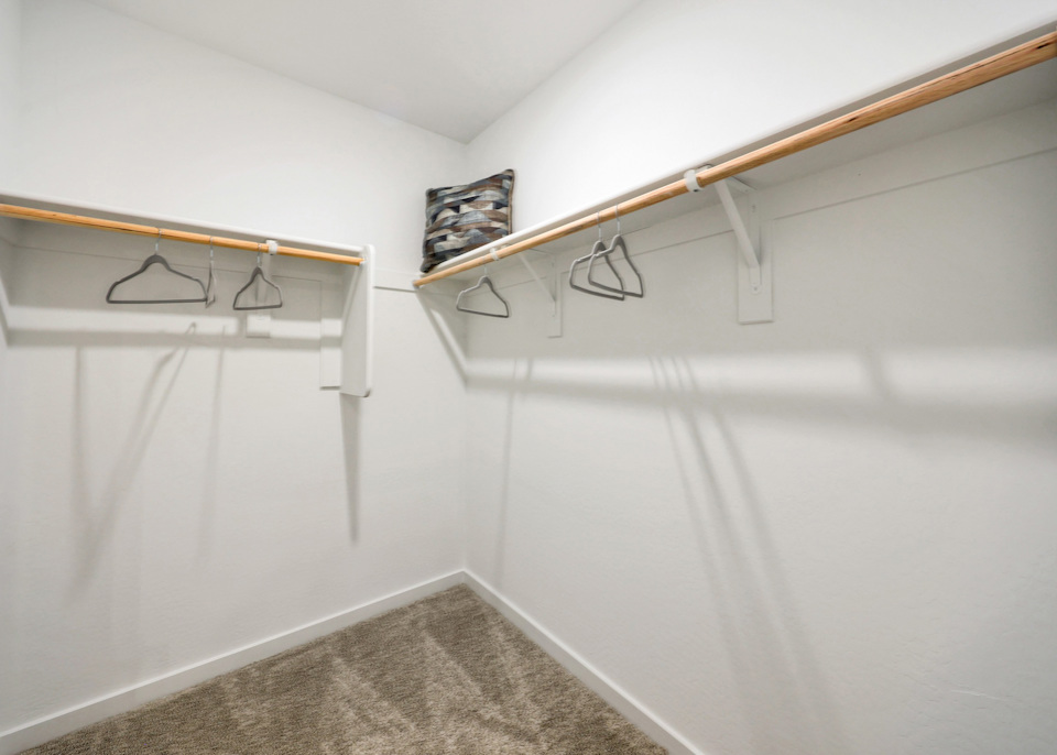 A white shower with a metal bar.