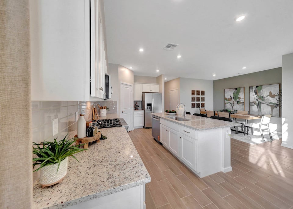 A kitchen with marble counters.