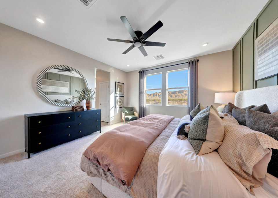 A large living room with a large fan and a large window.