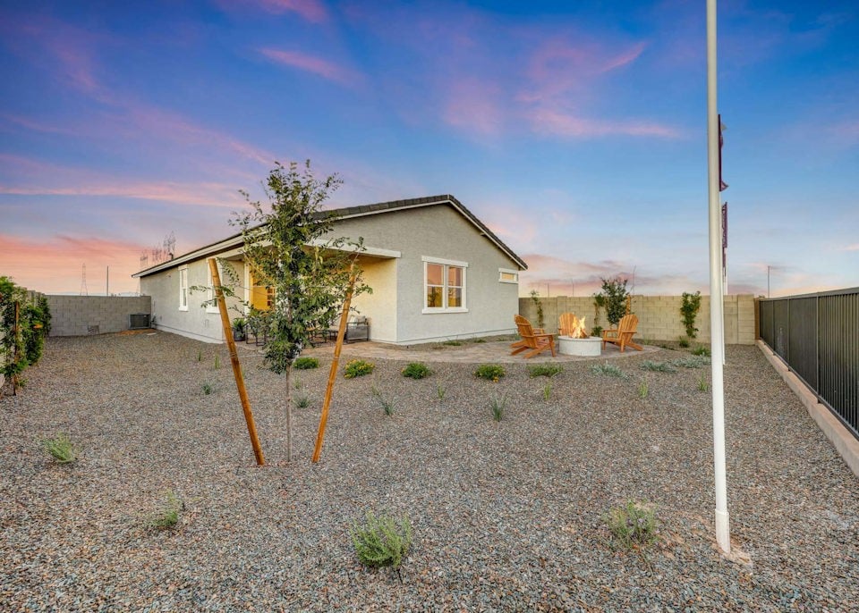 A house with a tree in the front yard.