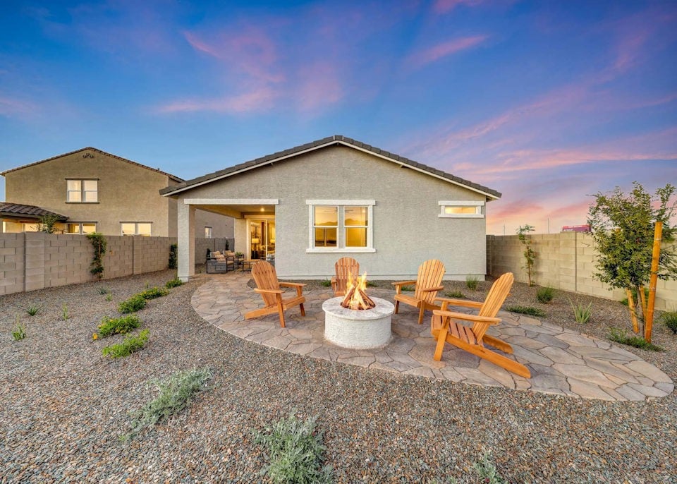A backyard with a fountain and chairs.