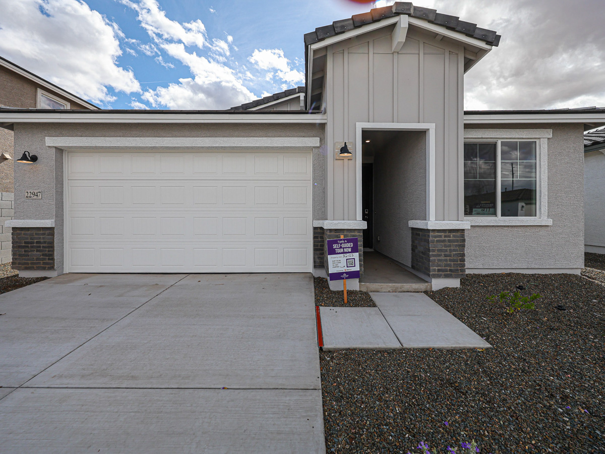 A garage with a sign in front of it.