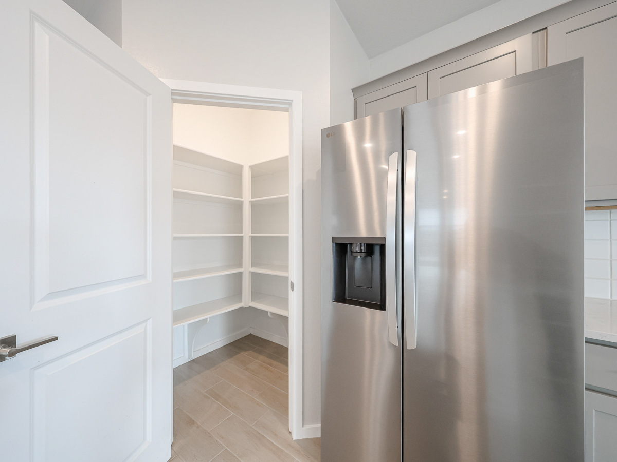 A kitchen with white cabinets.