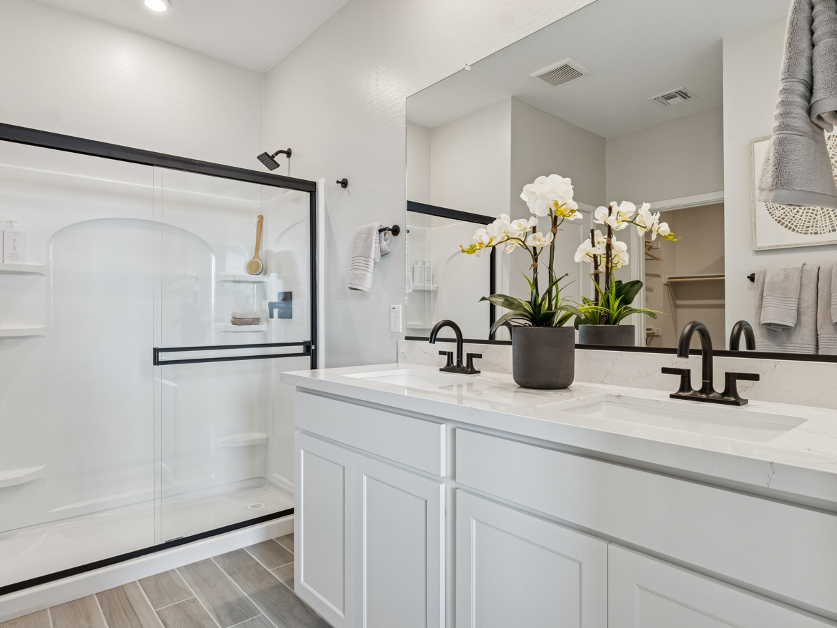 A bathroom with white cabinets.