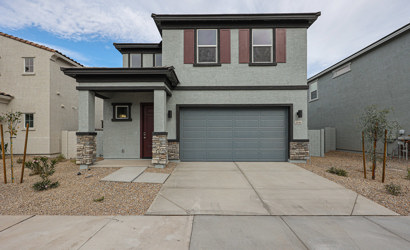 A grey house with a garage.
