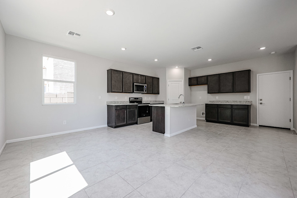 A kitchen with black cabinets.