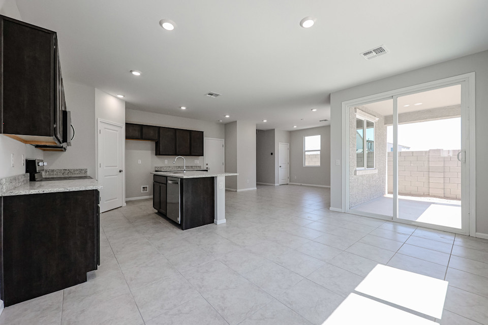 A large kitchen with white tiles.