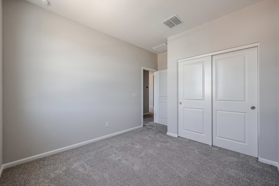A hallway with white doors.