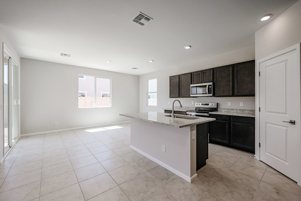 A kitchen with black cabinets.