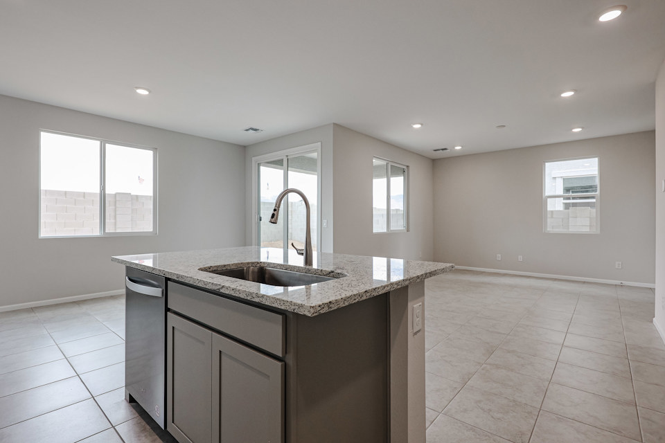 A large kitchen with marble counters.