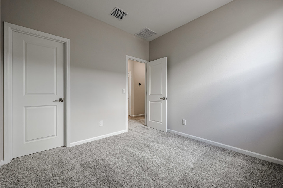A hallway with white doors.