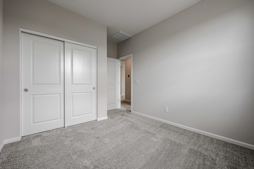A hallway with white doors.