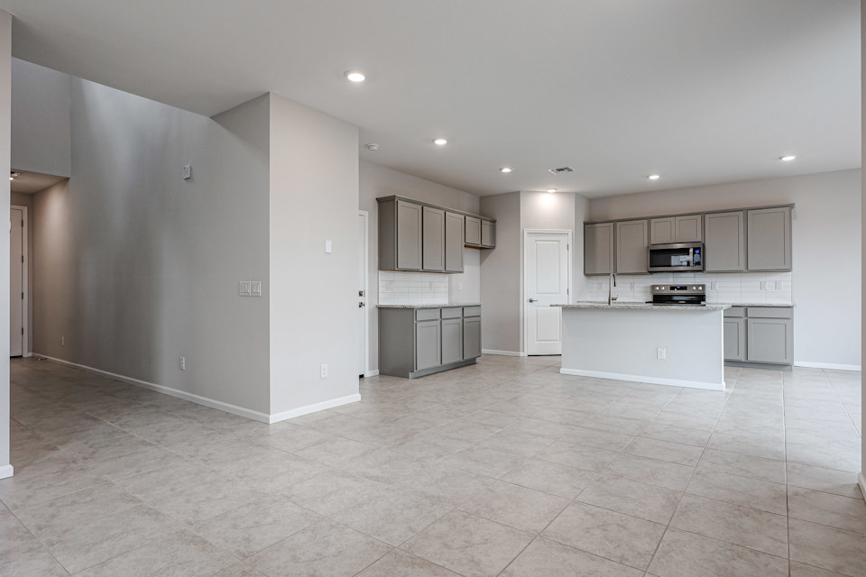 A kitchen with white cabinets.